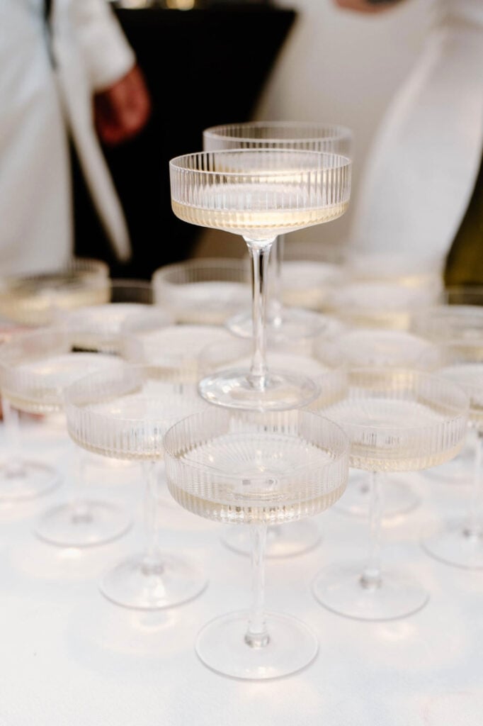 Stacked coupe glasses filled with sparkling wine at a Shortland Waters celebration event